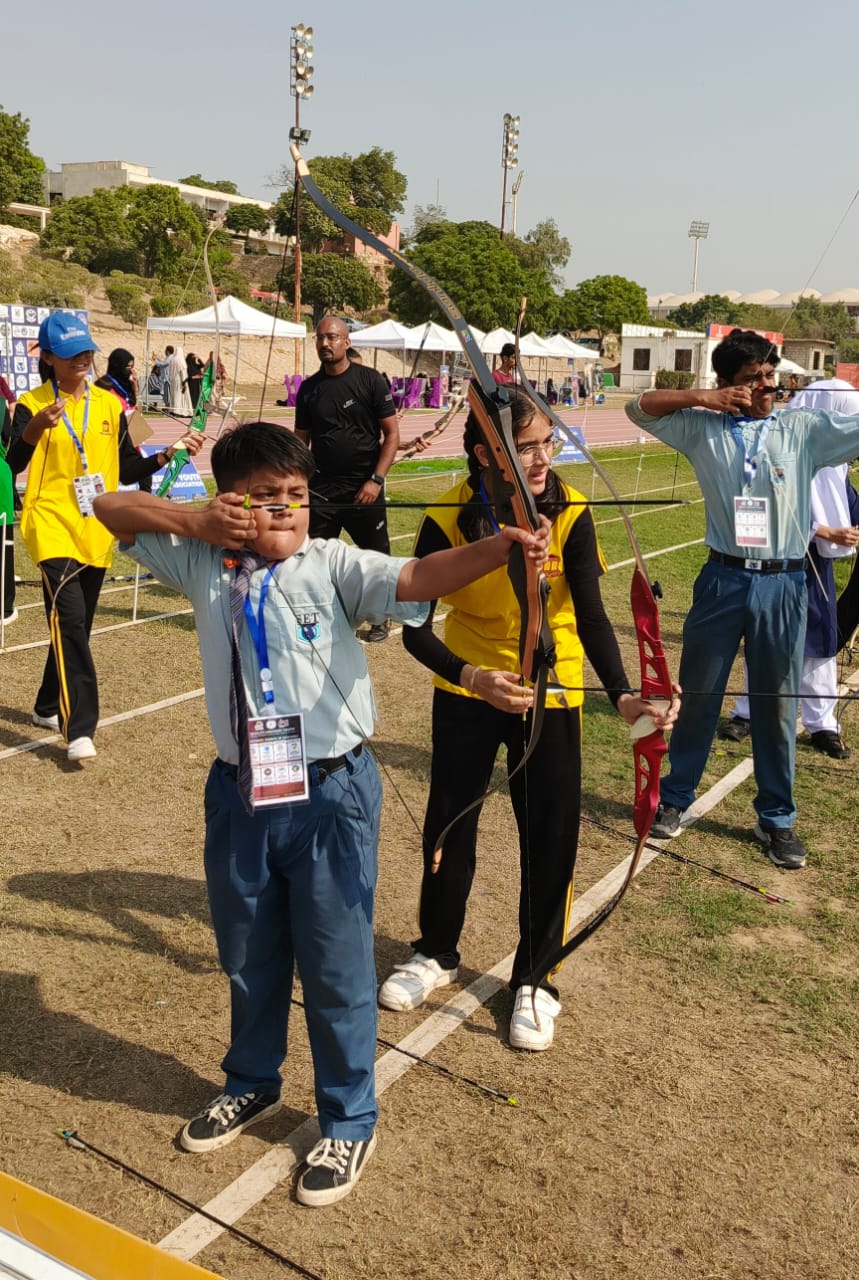 Participants aiming: "Precision in action: Archers showcase their talent during the competition."
